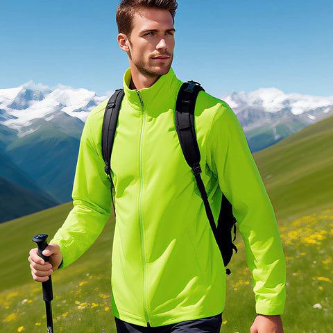 Man in a bright green jacket with a backpack hiking on a mountain